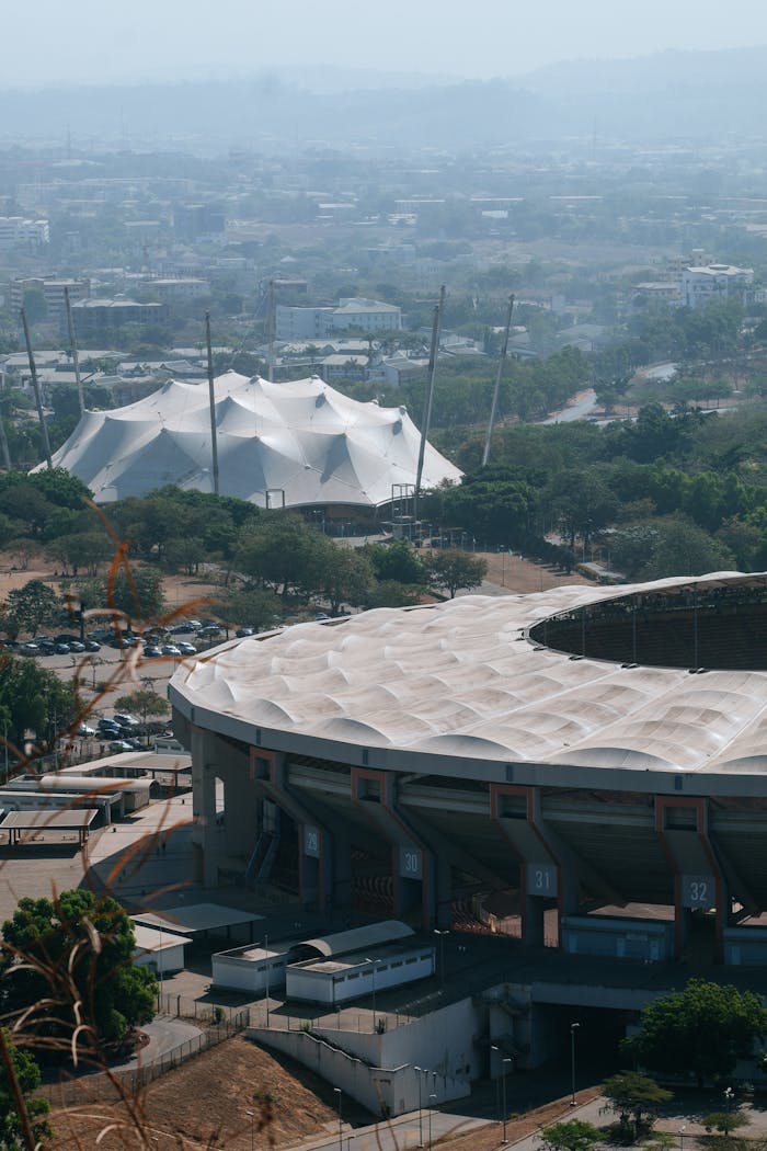 Home Aerial shot of Abuja, Nigeria highlighting modern architecture and cityscape.